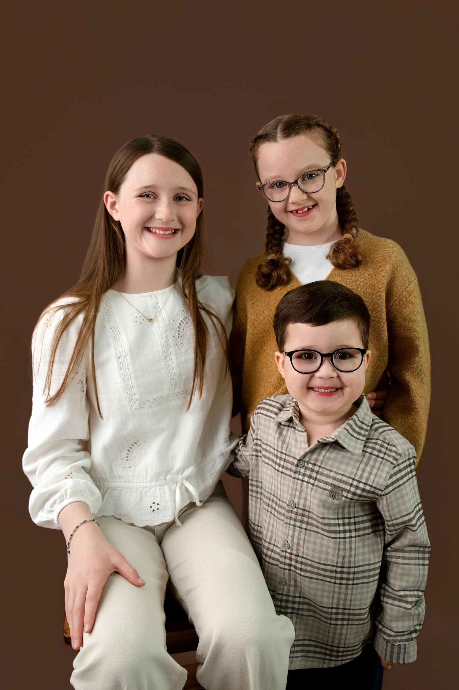 Two people pose together in coordinating outfits of brown plaid and white, showing their close bond across multiple photos.