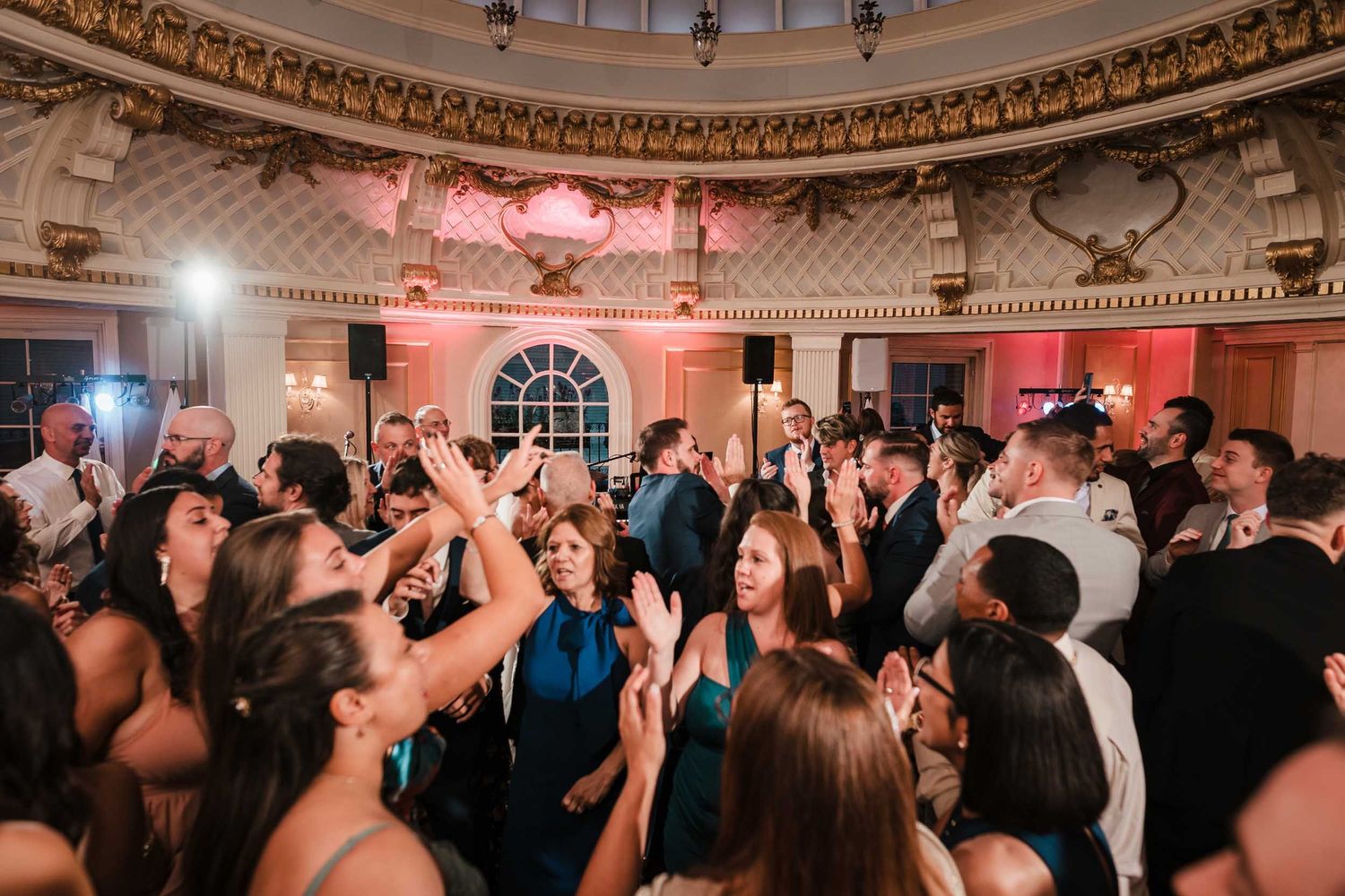 High-energy wedding reception dance floor in the Dome Room at Lenox Hotel Boston with guests celebrating