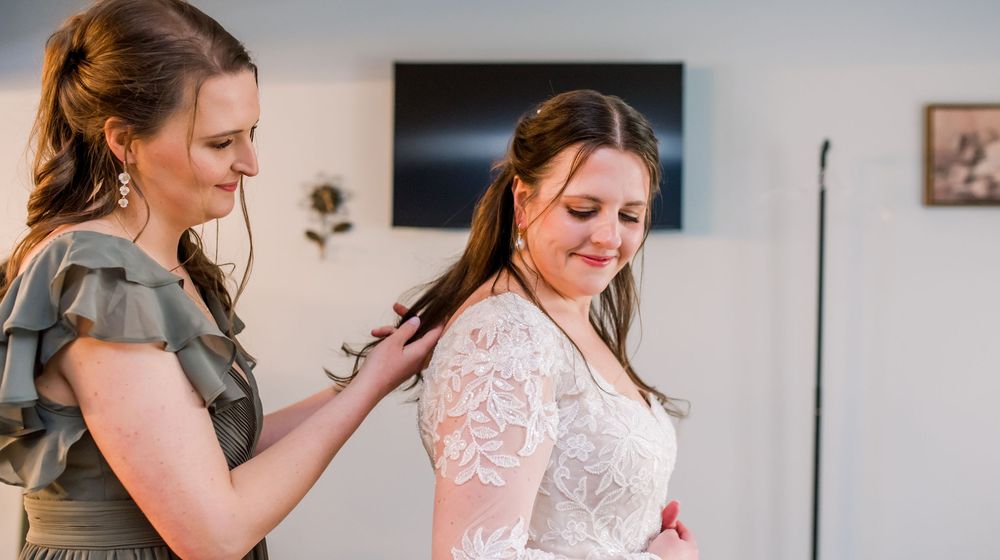 A series of candid getting-ready moments captured in mirror reflections with soft indoor lighting.