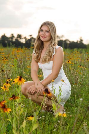 A series of outdoor portraits in a sunflower field with a white summer dress creating a dreamy summer atmosphere.