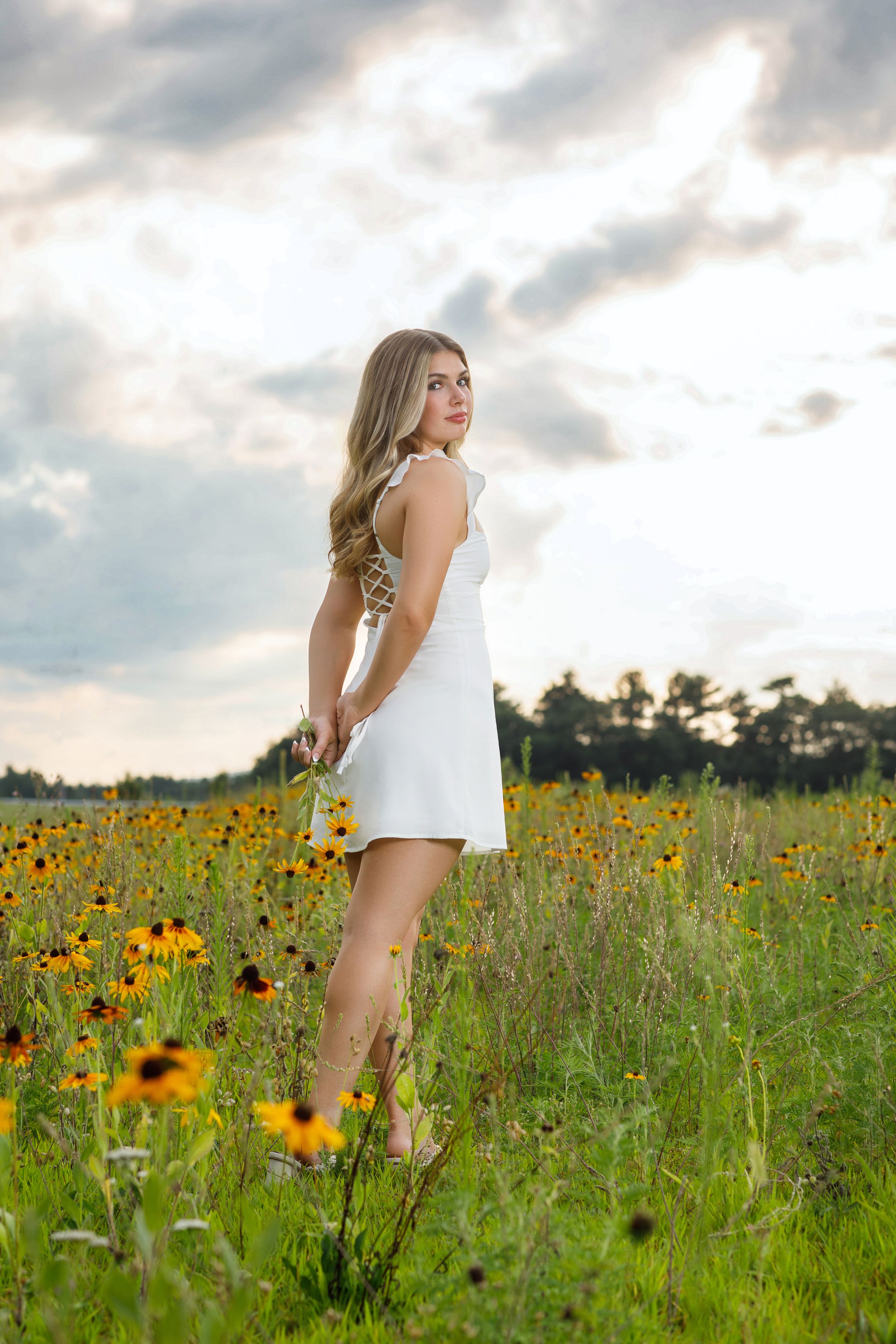 Portrait session in a vibrant wildflower meadow with black-eyed susans at golden hour.