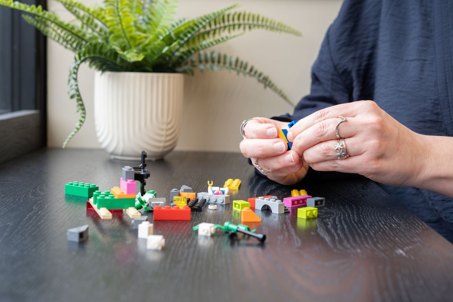 Life coach using bricks to help people communicate, photographed by BLOOM Fabulous Photography