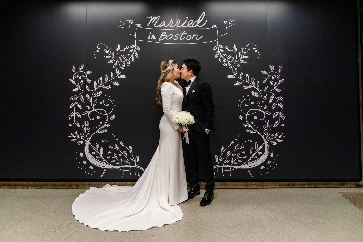 Couple kissing at Boston City Hall after their courthouse wedding ceremony in Boston, Massachusetts.
