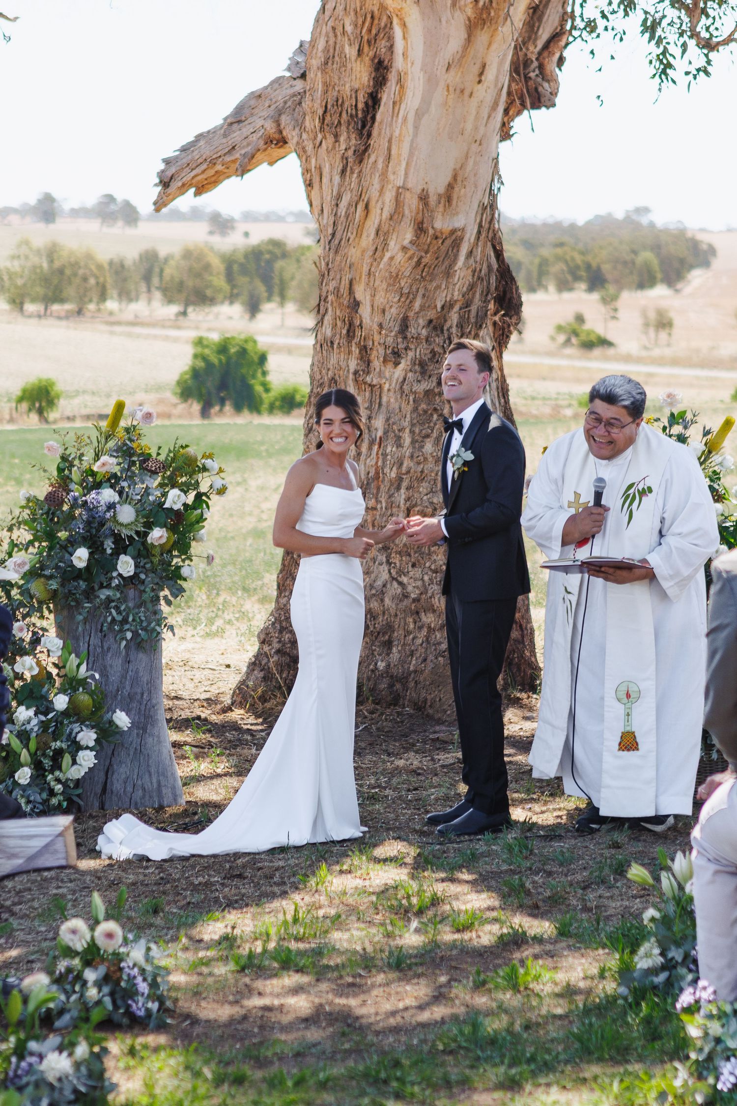 Bride and groom smiling during ceremony at country NSW wedding