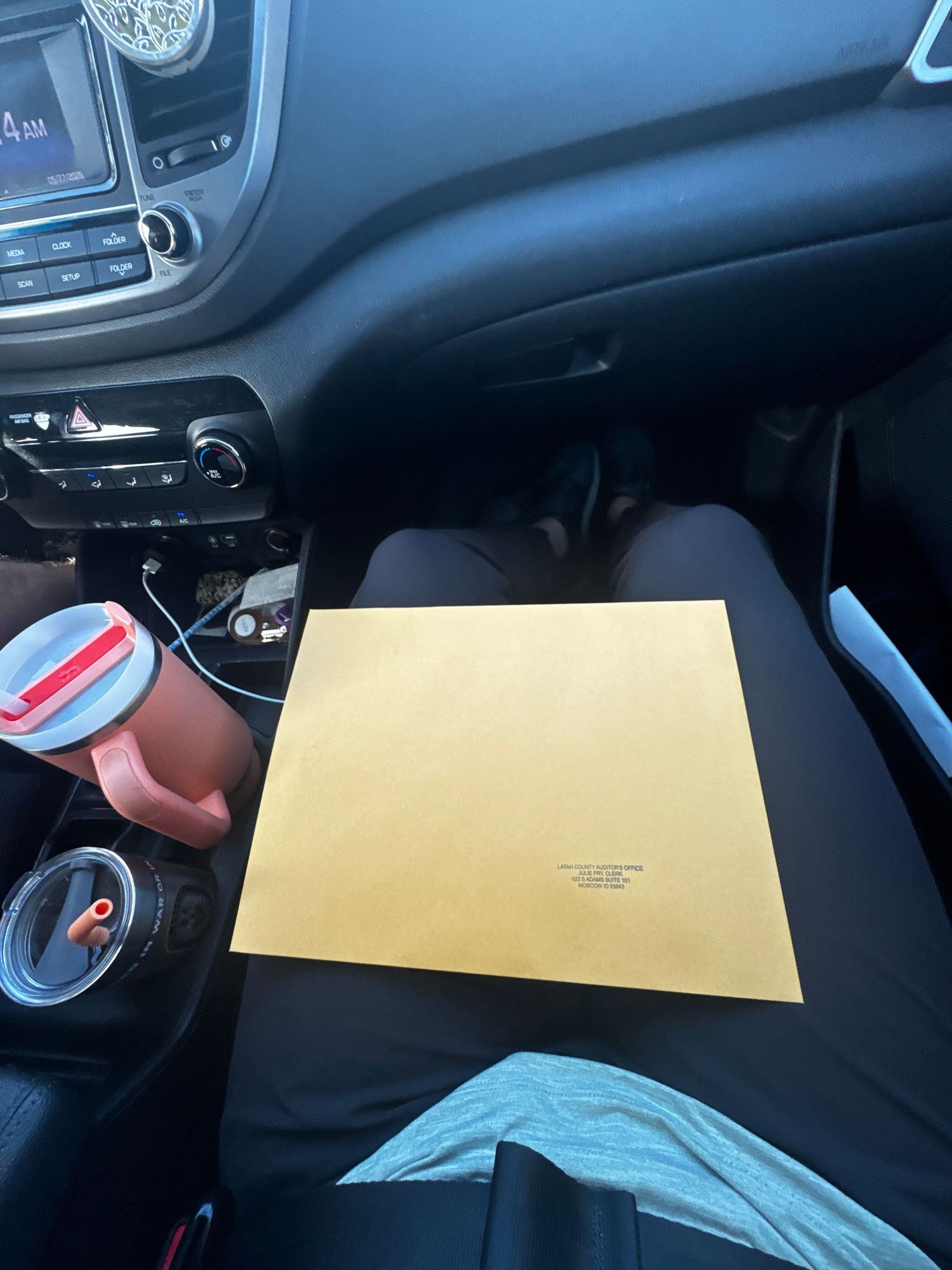 An official document with signatures and a gold seal lies on a wooden table surface.
