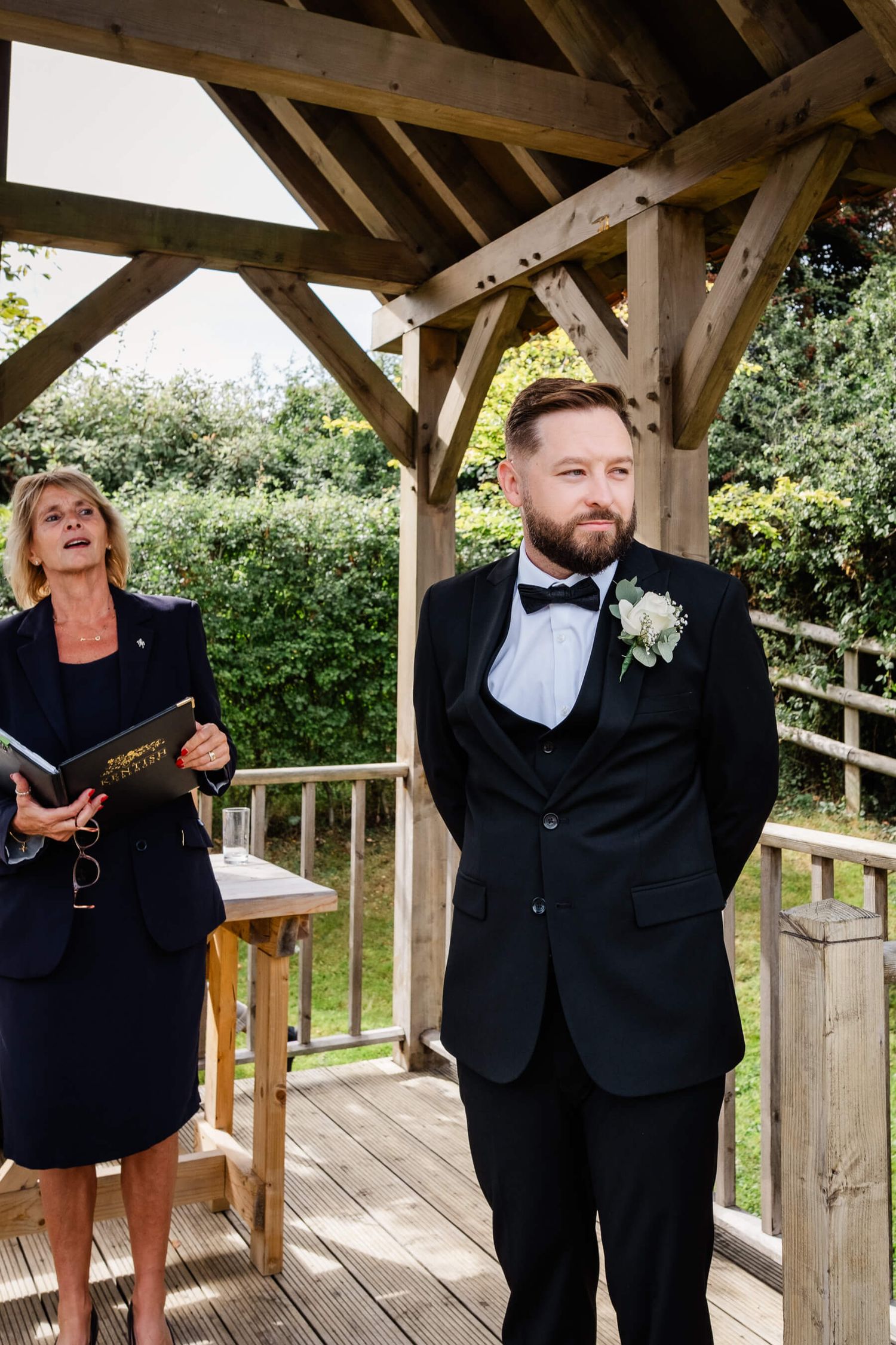 Groom waiting for the bride to walk down the aisle at reach court farm