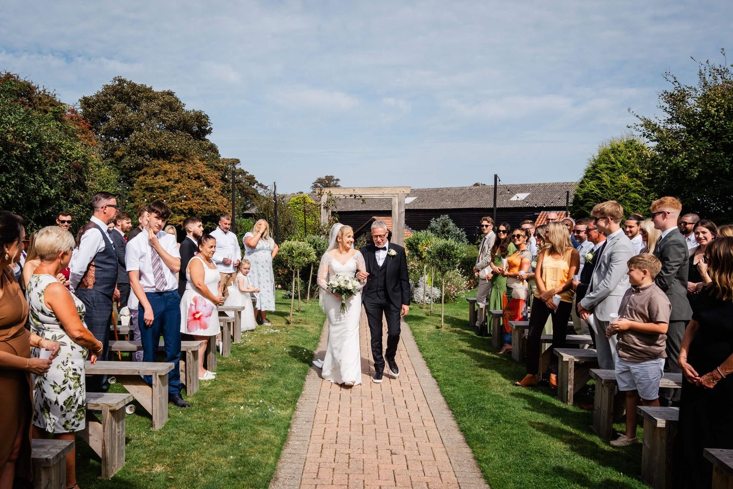 bride and father of the groom walking down the aisle