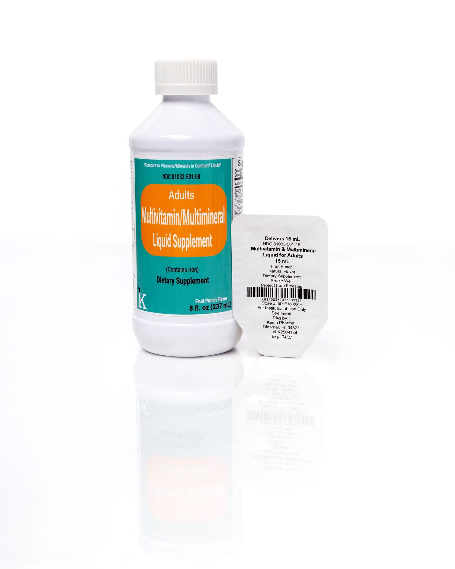 White bottle of liquid medication with orange label and small packet on reflective surface against white background.