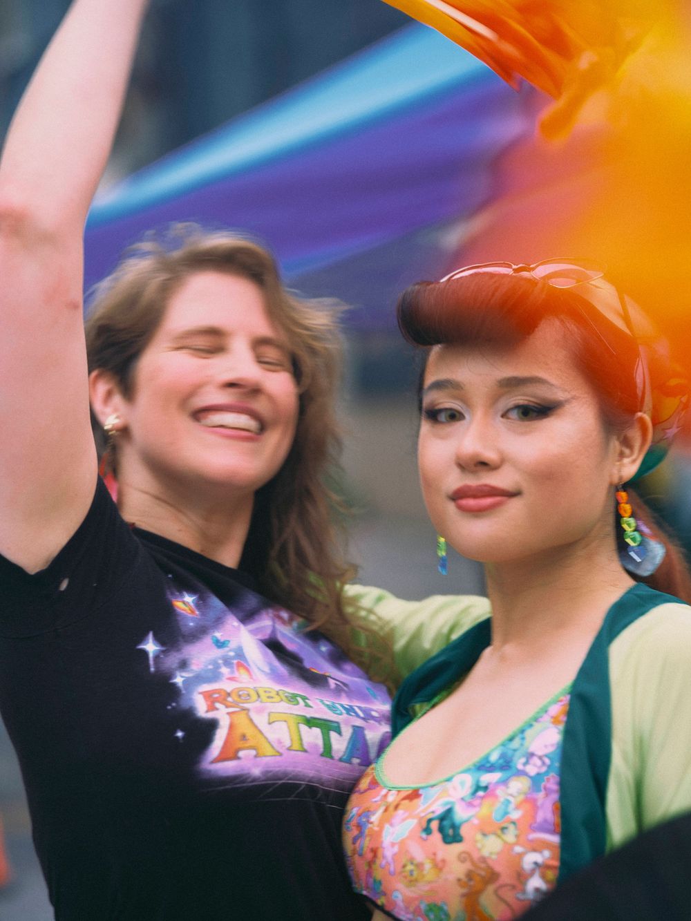 Joyful photo of two women holding Pride flag at Baltimore Pride in Mount Vernon.