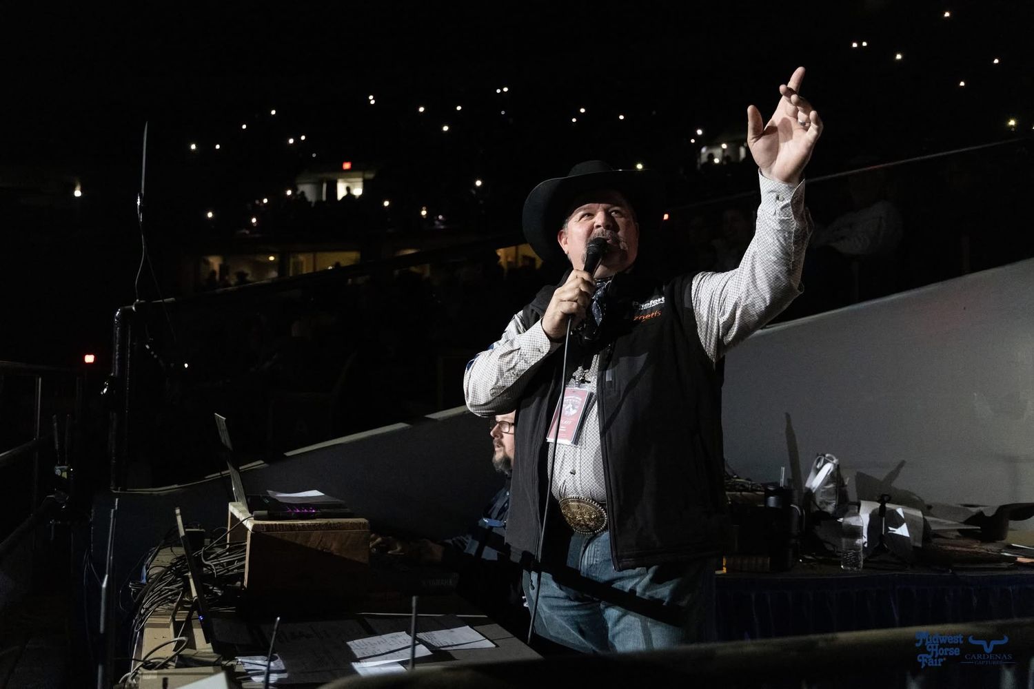 Kelly Kenny silhouetted against dark background at nighttime outdoor event. Wisconsin Pro Rodeo PRCA Rodeo Photographer Dakota Cardenas