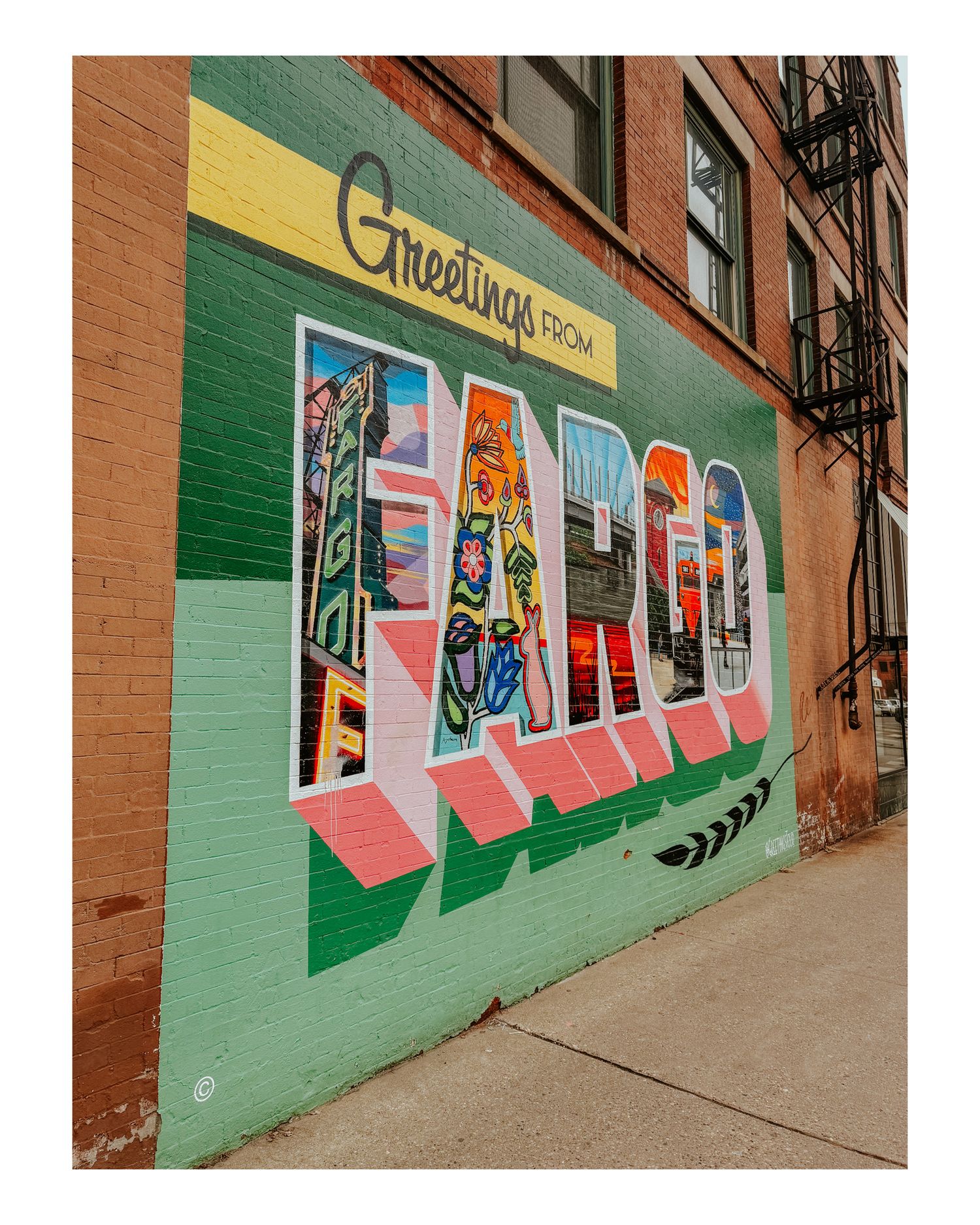 Colorful mural on brick wall spelling out 'Fargo' in artistic lettering with vibrant designs.