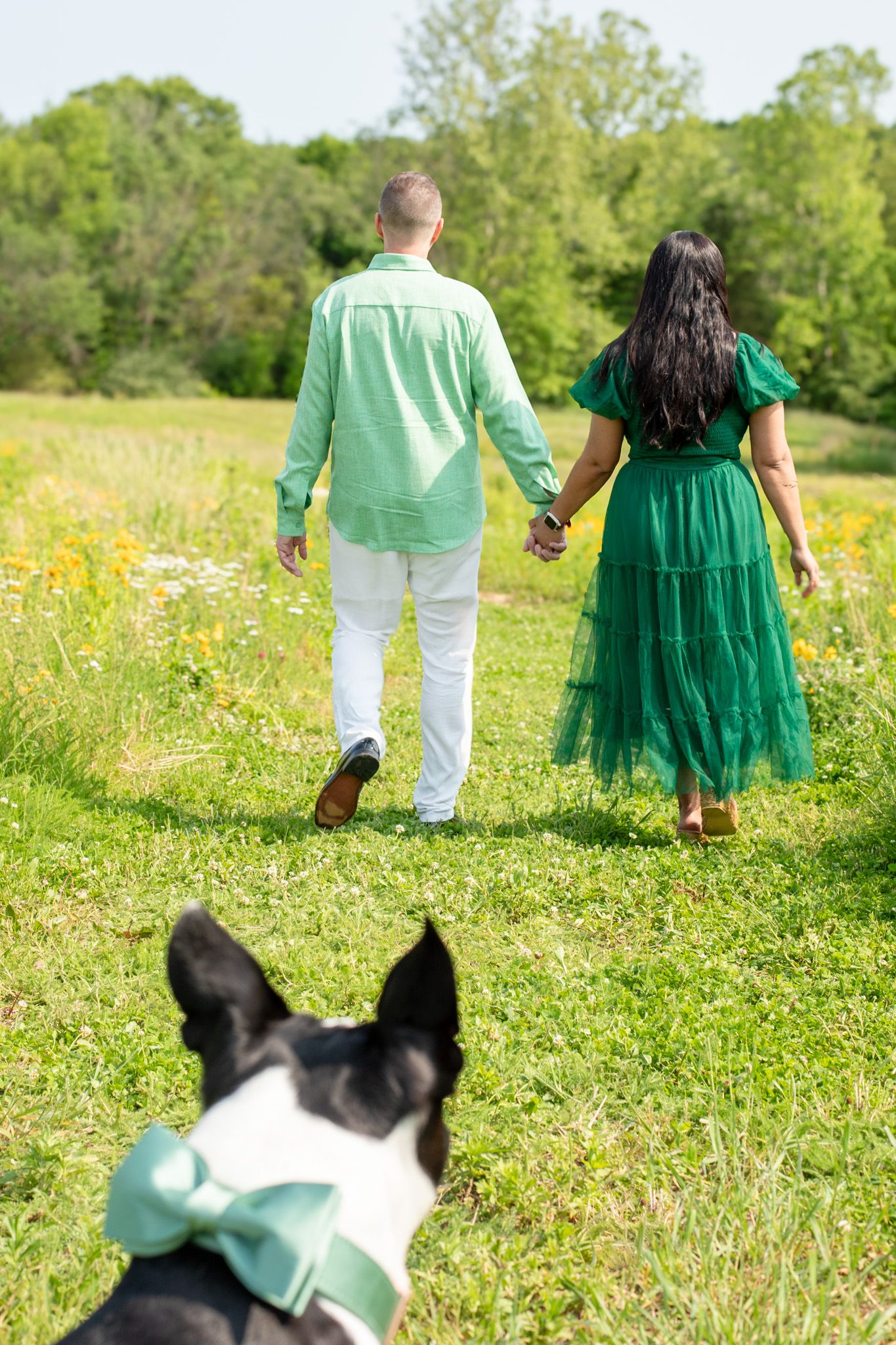 Couple with dog in Cincinnati farm wildflower field showcasing high-end, elegant outdoor photography for premium clients
