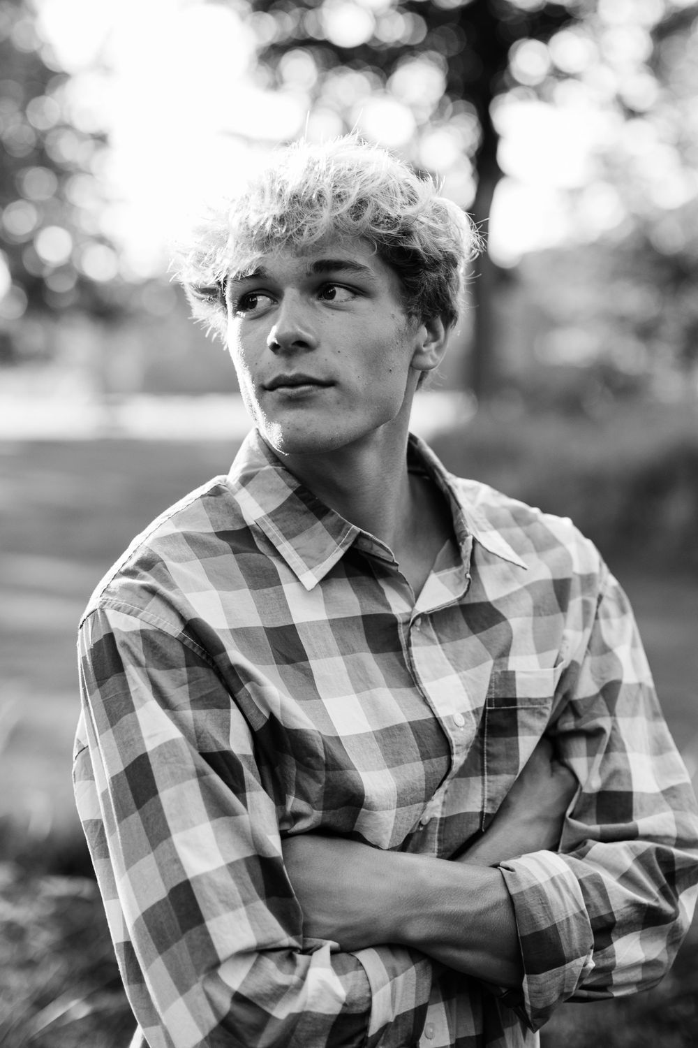 Dramatic black and white portrait series showing expressions in plaid shirt.