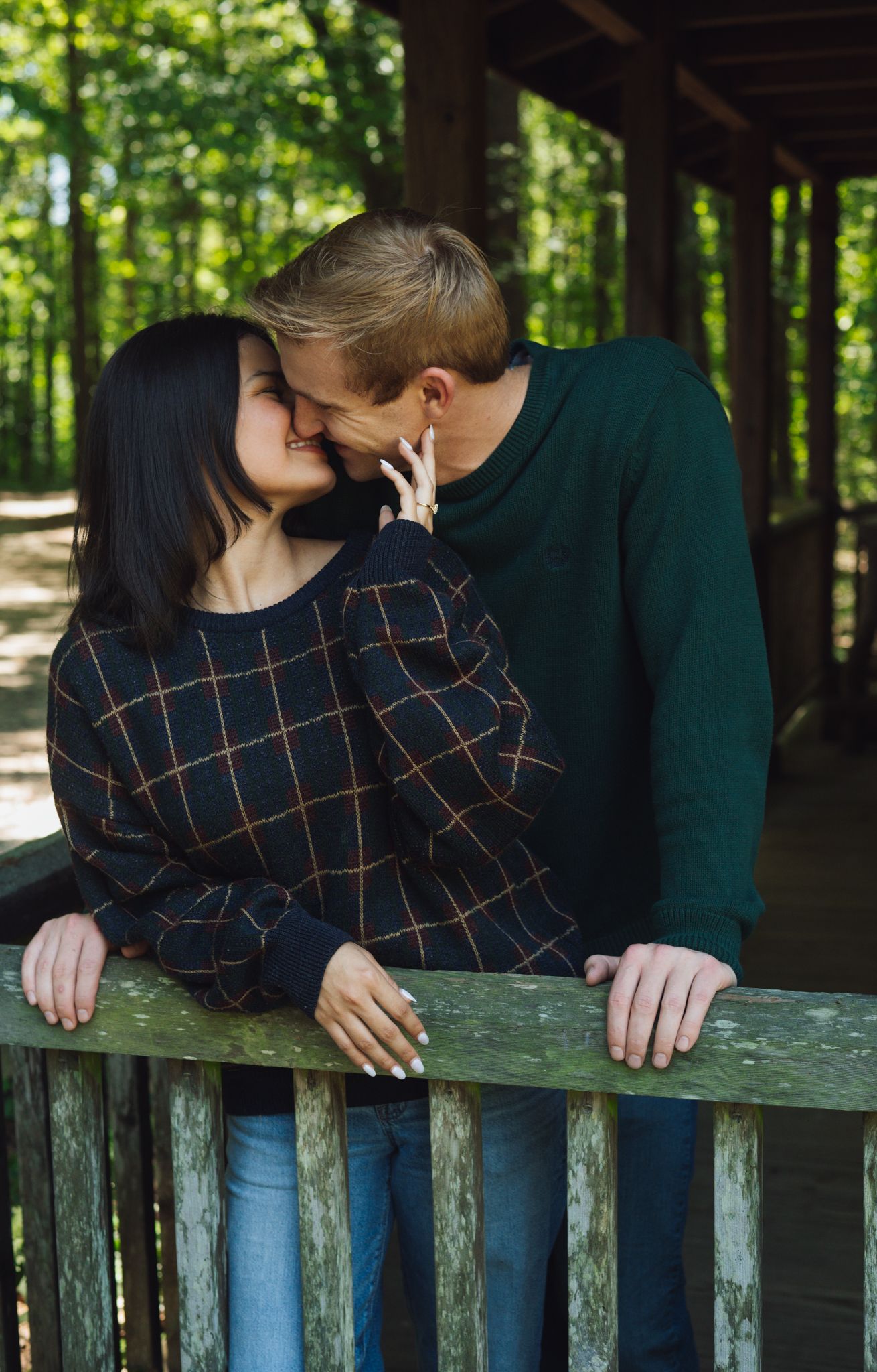 Couple sharing intimate moment among yellow wildflowers in springtime meadow.