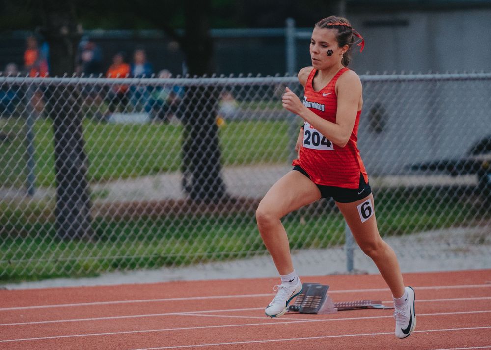 Sports Photography of NorthWood runner competing on outdoor track during daytime event - Warsaw, Indiana