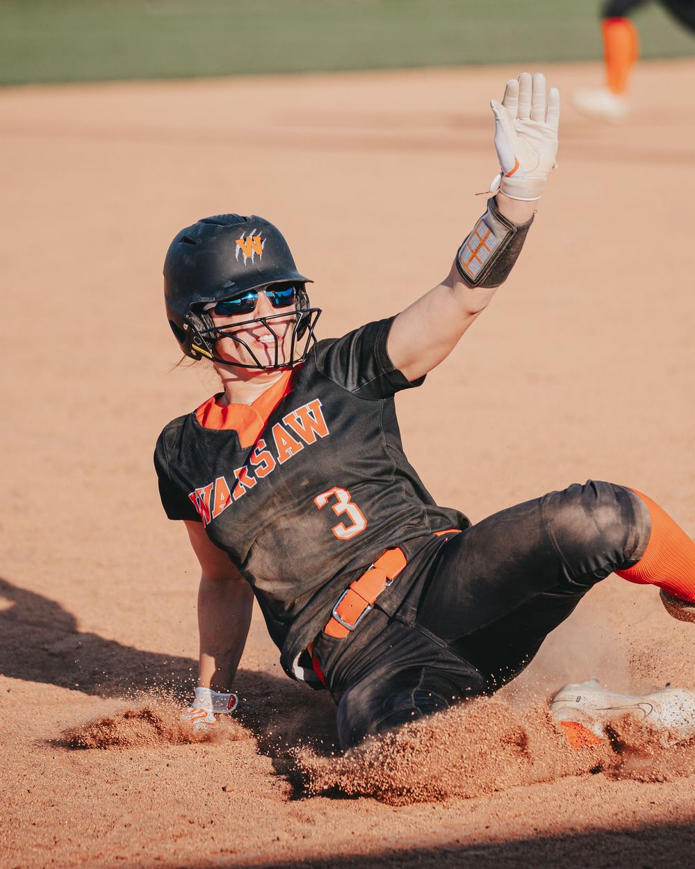 Sports Photography of softball player sliding into base during intense game action - Warsaw, Indiana