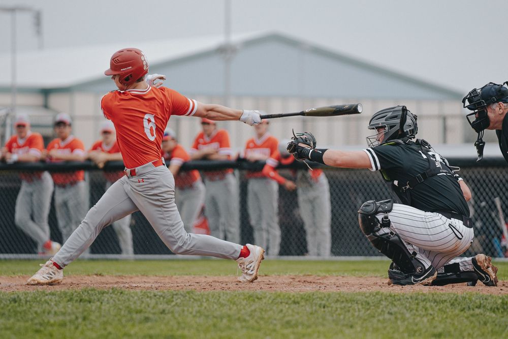 Sports Photography of baseball game action shot of batter swinging with catcher in defensive position  - Warsaw, Indiana