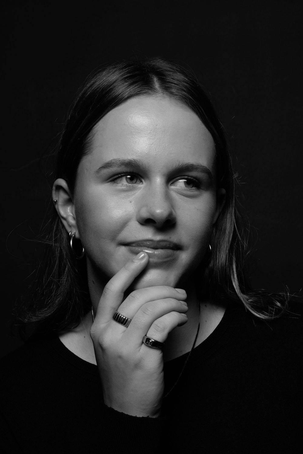 A sequence of dark black and white portraits showing expressive emotions in dramatic lighting.
