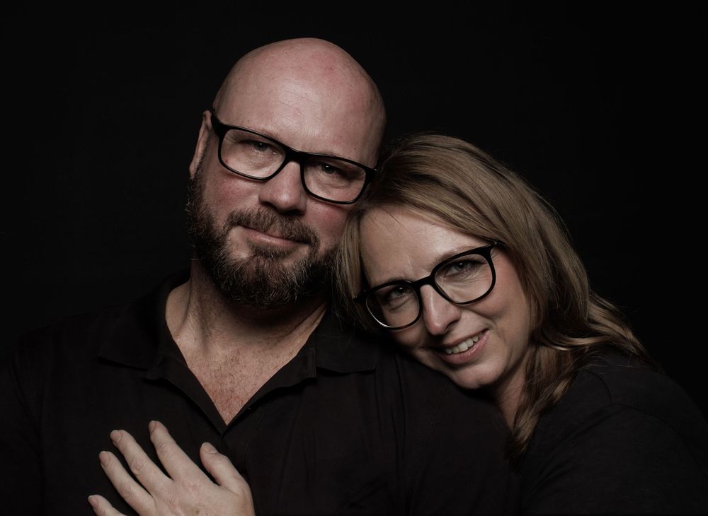 A series of intimate black and white portraits showing closeness between two people against dark background.