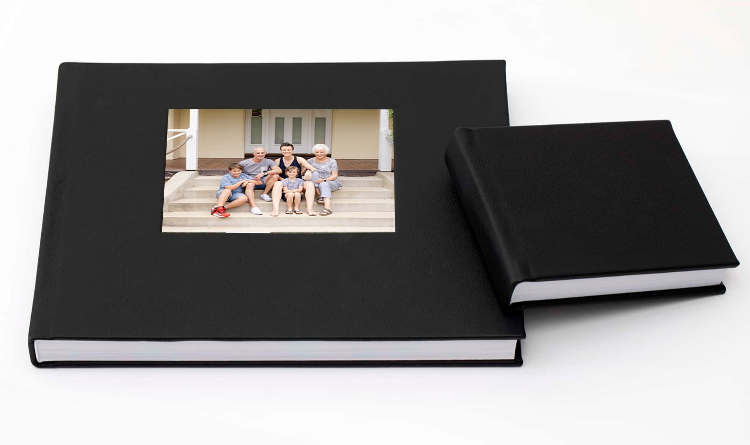 Two black hardcover photo albums with display windows shown side by side on white background.