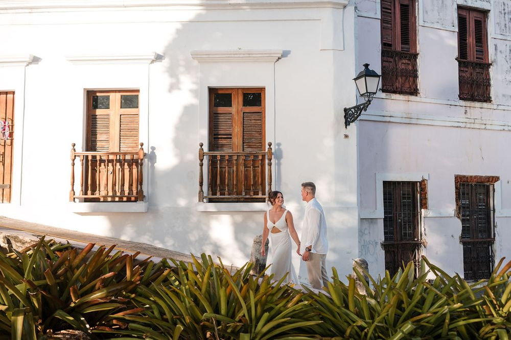 Couple walking in front of colonial building in Old San Juan Puerto Rico engagement session
