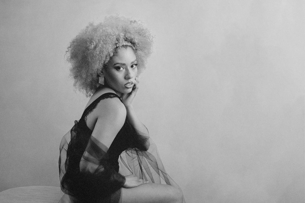A series of vintage black and white glamour photographs showing a figure in different poses against a light background.