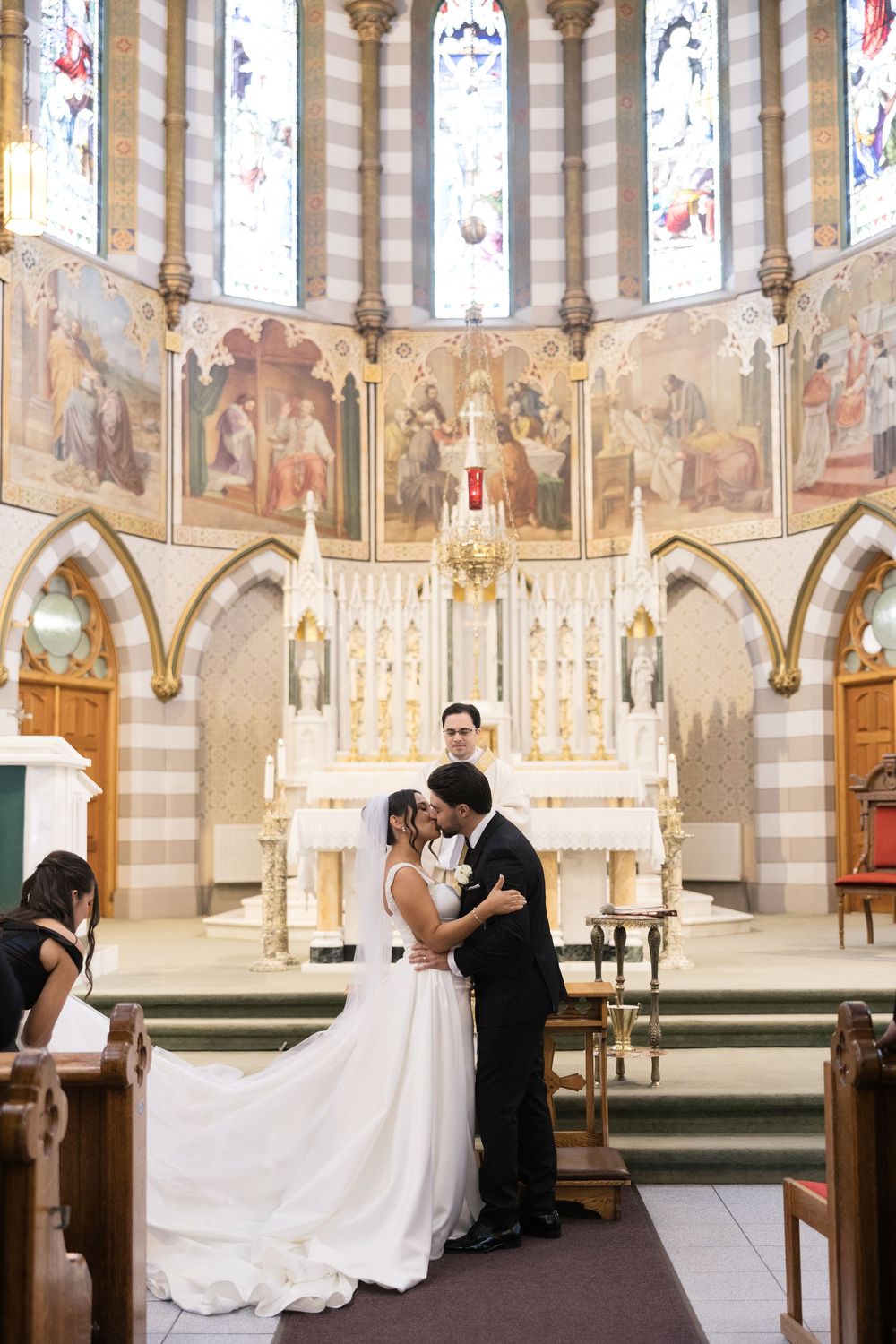 A sequence of wedding photos showing a couple in a grand cathedral with ornate stained glass windows and gothic architecture.