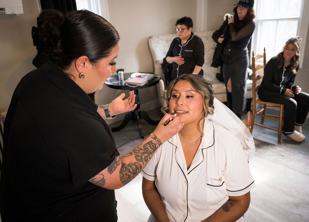 Wedding preparation scene with people getting ready in a bright indoor space.