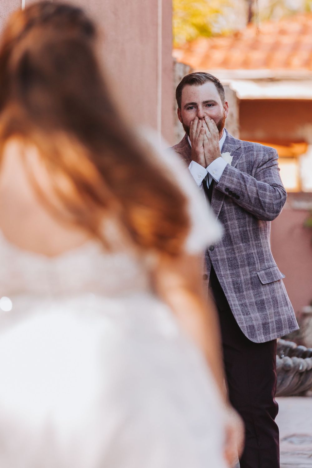 A series of wedding photos showing an emotional reaction during a first look moment at an outdoor venue.