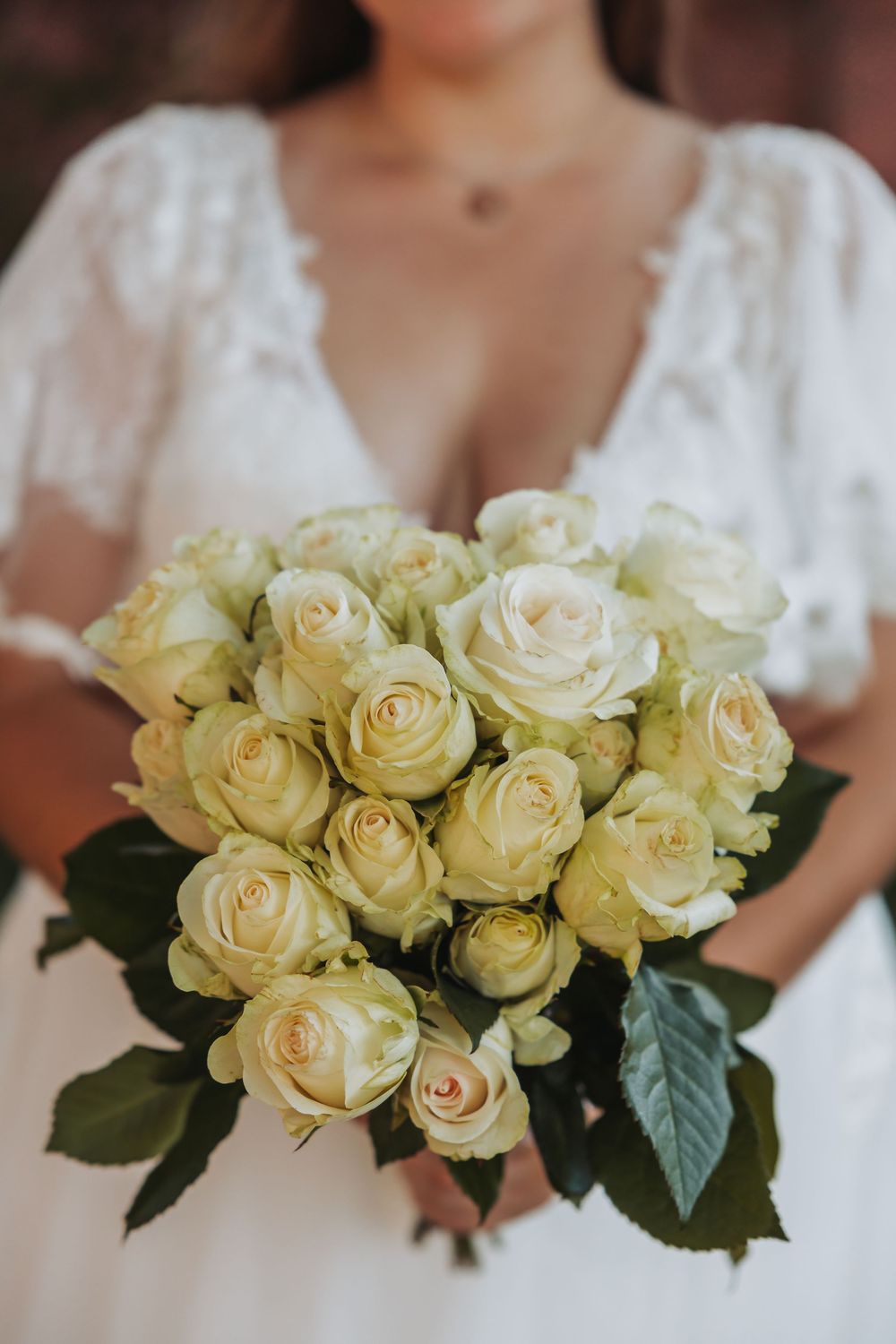 A series of elegant cream-colored roses arranged in wedding bouquets against a soft blurred background.
