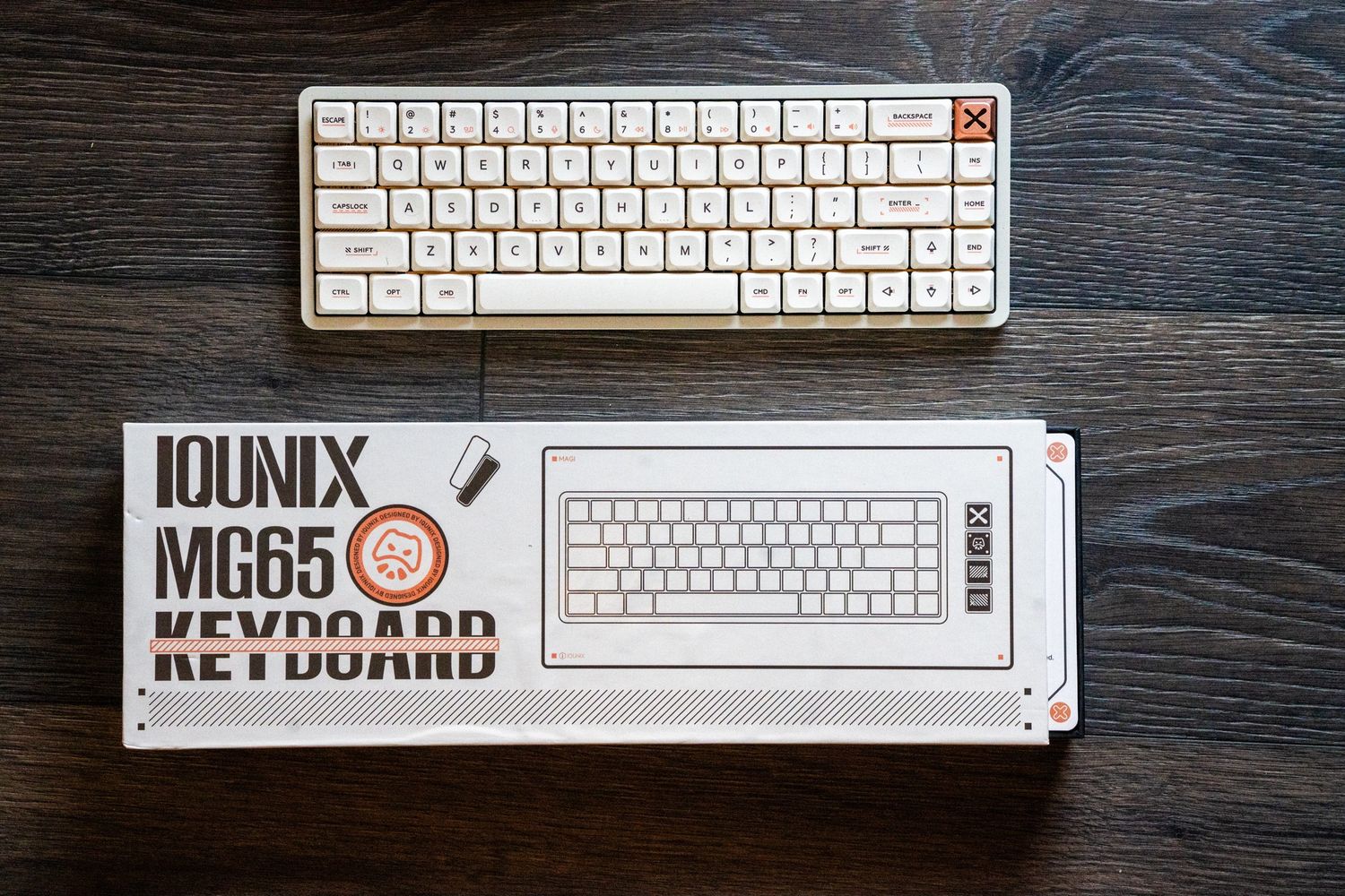 Multiple minimalist white computer keyboards arranged in a row on a dark wooden surface.