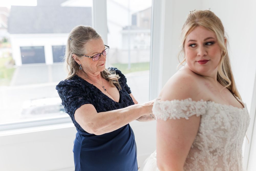 A series of photos showing final adjustments being made to a white wedding dress in a bright room.