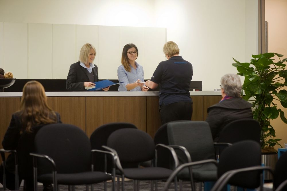 Healthcare professionals collaborating in a modern medical office meeting room setting.