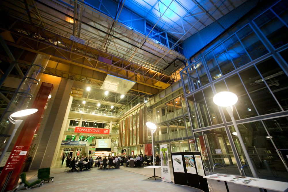 Modern industrial interior space with high ceilings and ambient lighting.