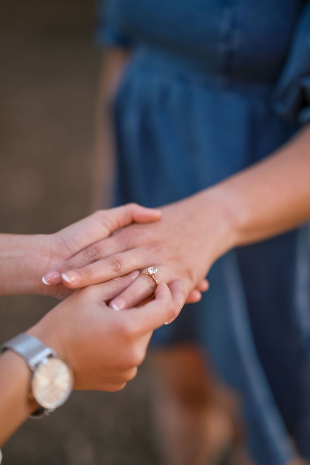 Close-up series of hands showing an engagement ring proposal moment in soft lighting.