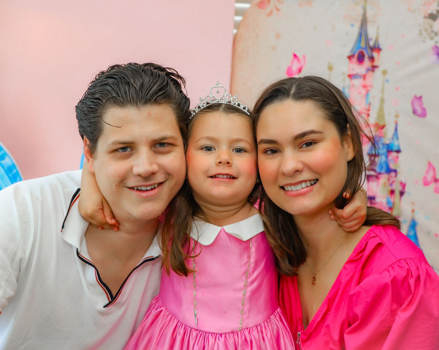 A collection of five family photos showing people wearing pink outfits and smiling together in casual portrait settings.