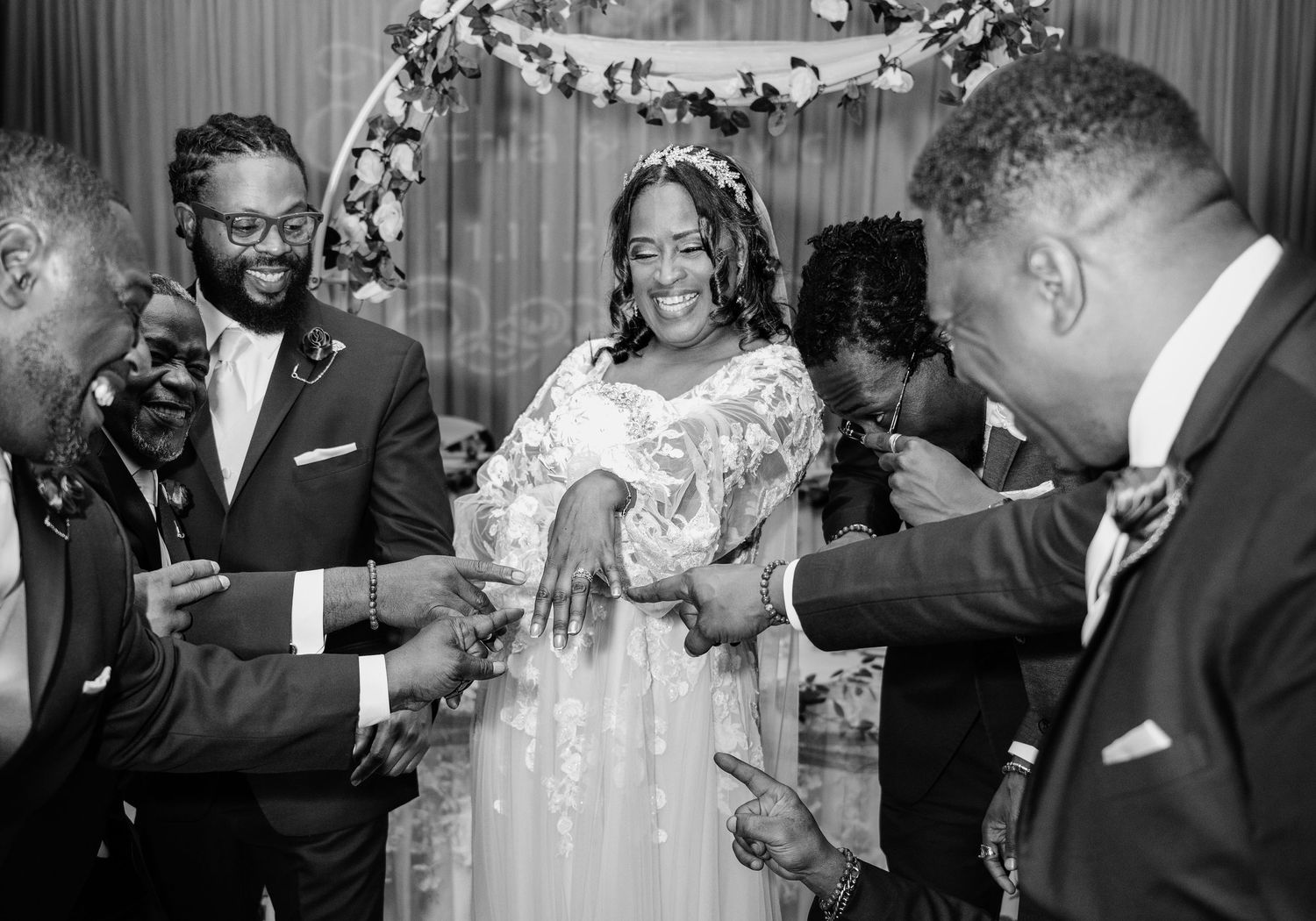 A joyful wedding celebration moment captured in black and white with guests celebrating.