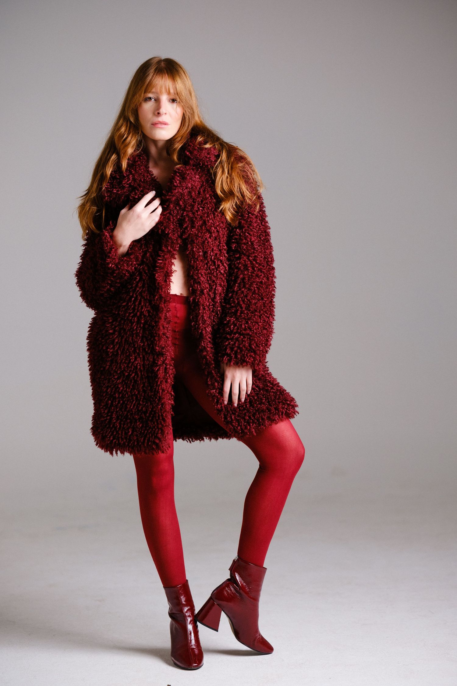 Fashion photo series featuring burgundy textured coat and matching leggings.