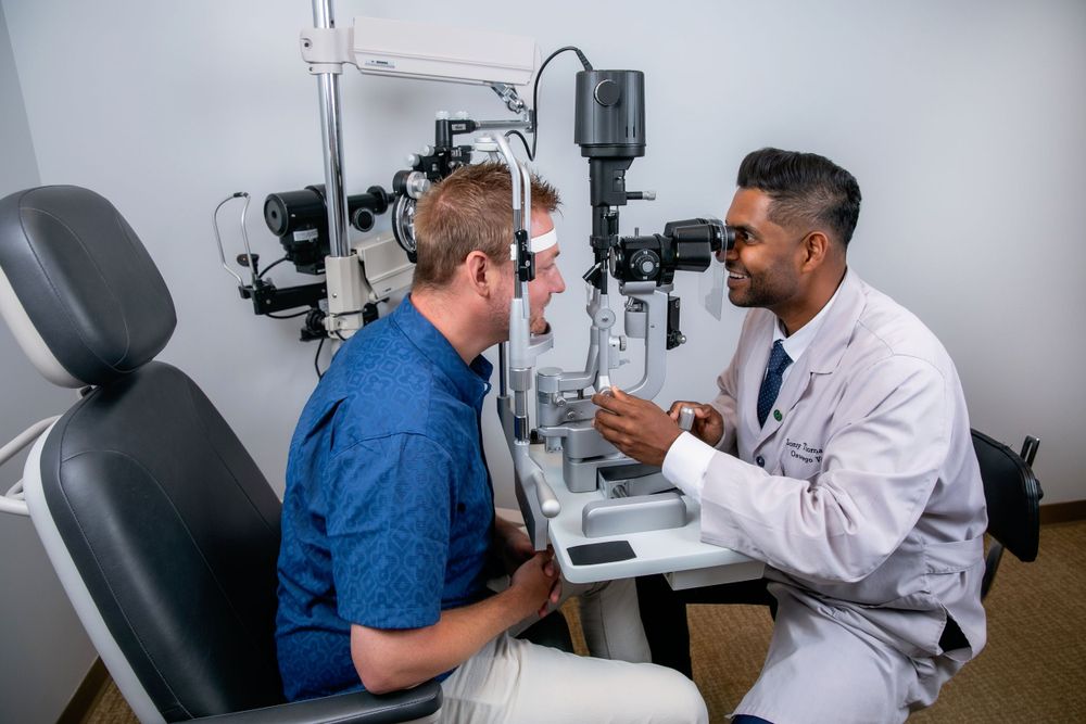Eye doctor conducting vision examination with medical equipment in modern clinic.