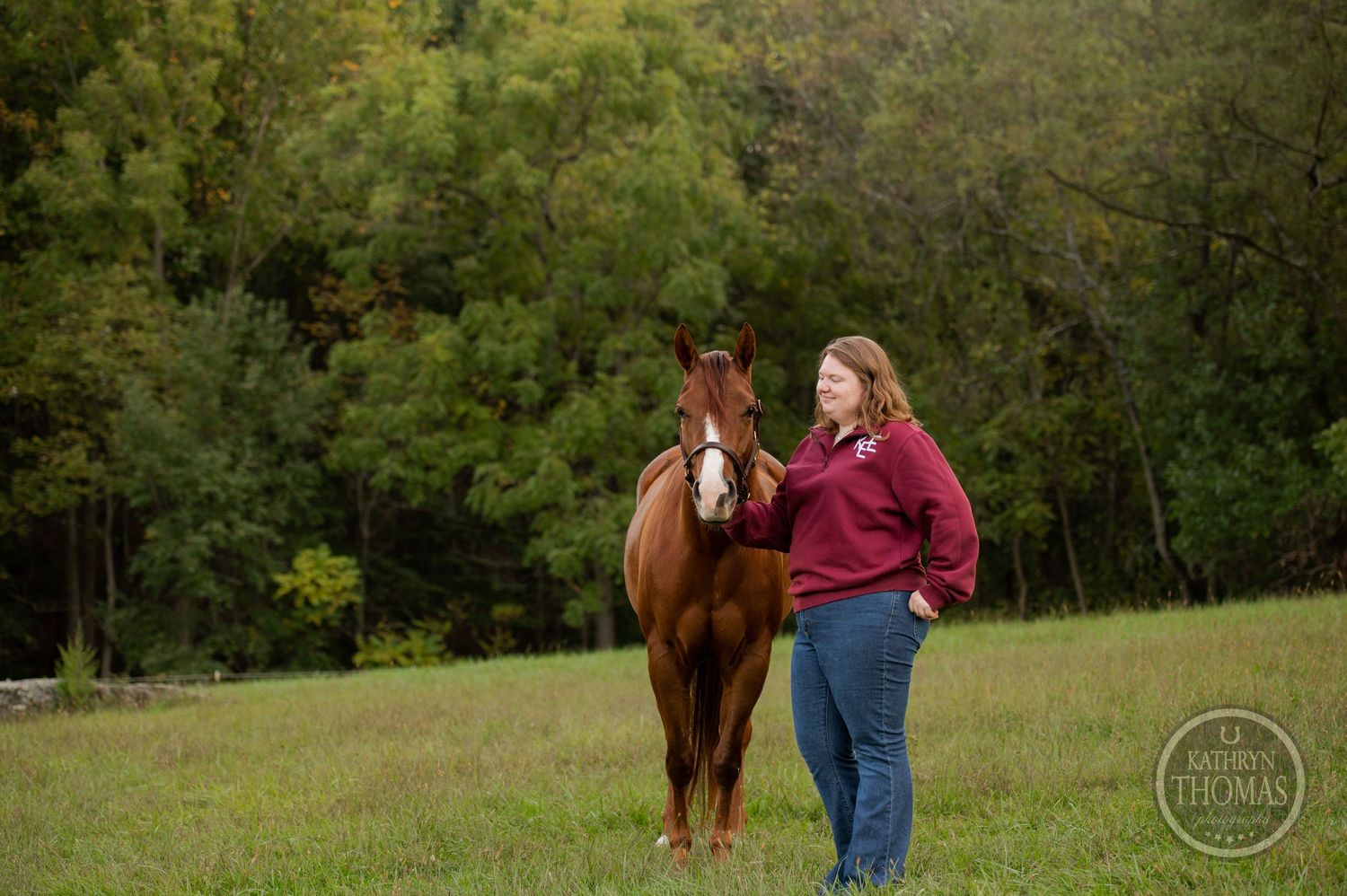 Horse and person enjoying an autumn day in a pastoral field setting.