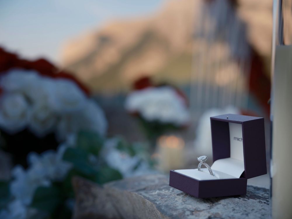 A ring in the foreground at Lake Minnewanka in Banff during a proposal photoshoot