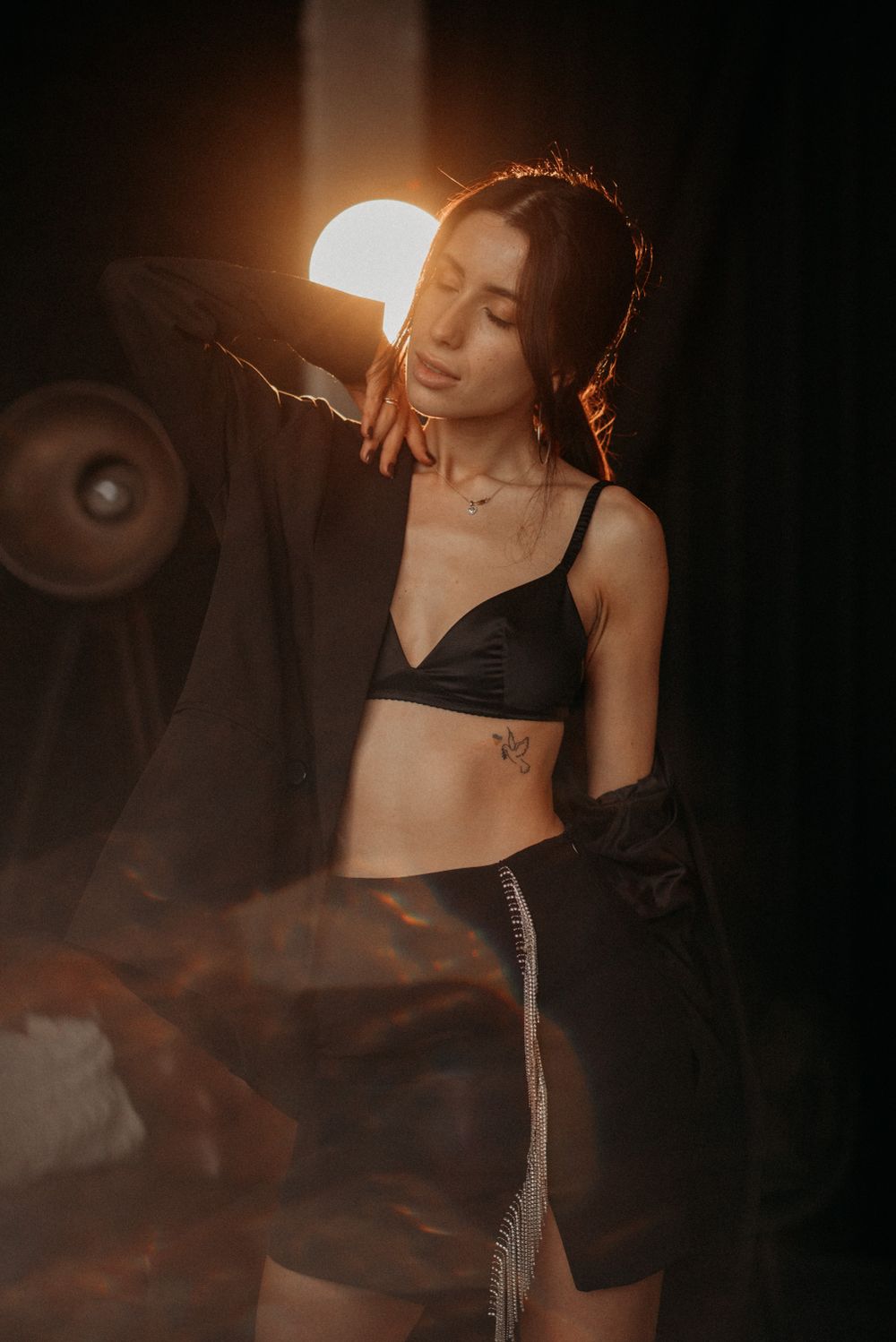 Artistic boudoir photo series with dramatic lighting and shadows creating a moody atmosphere.