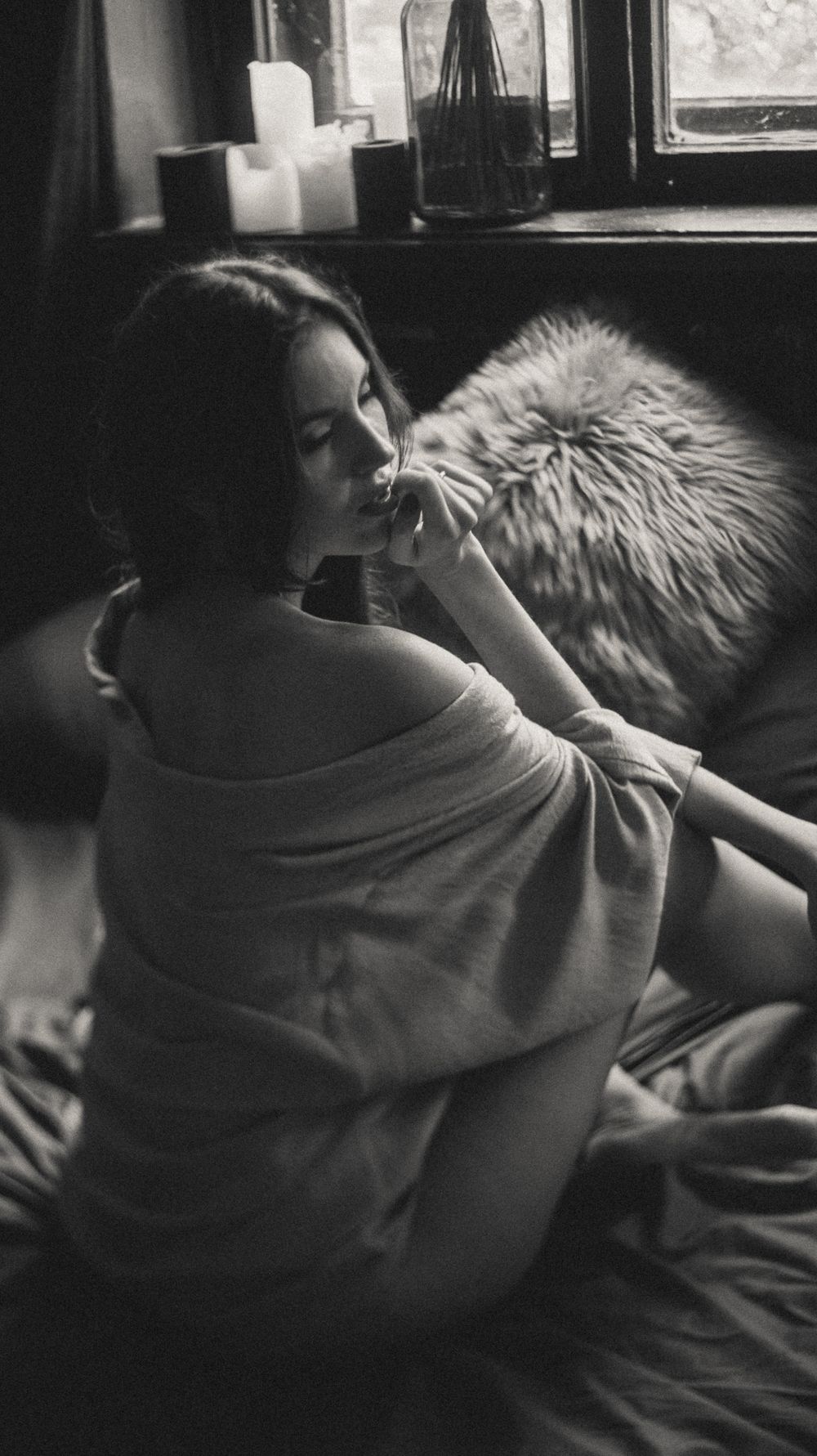 Candid black and white series showing relaxed moments by a window.
