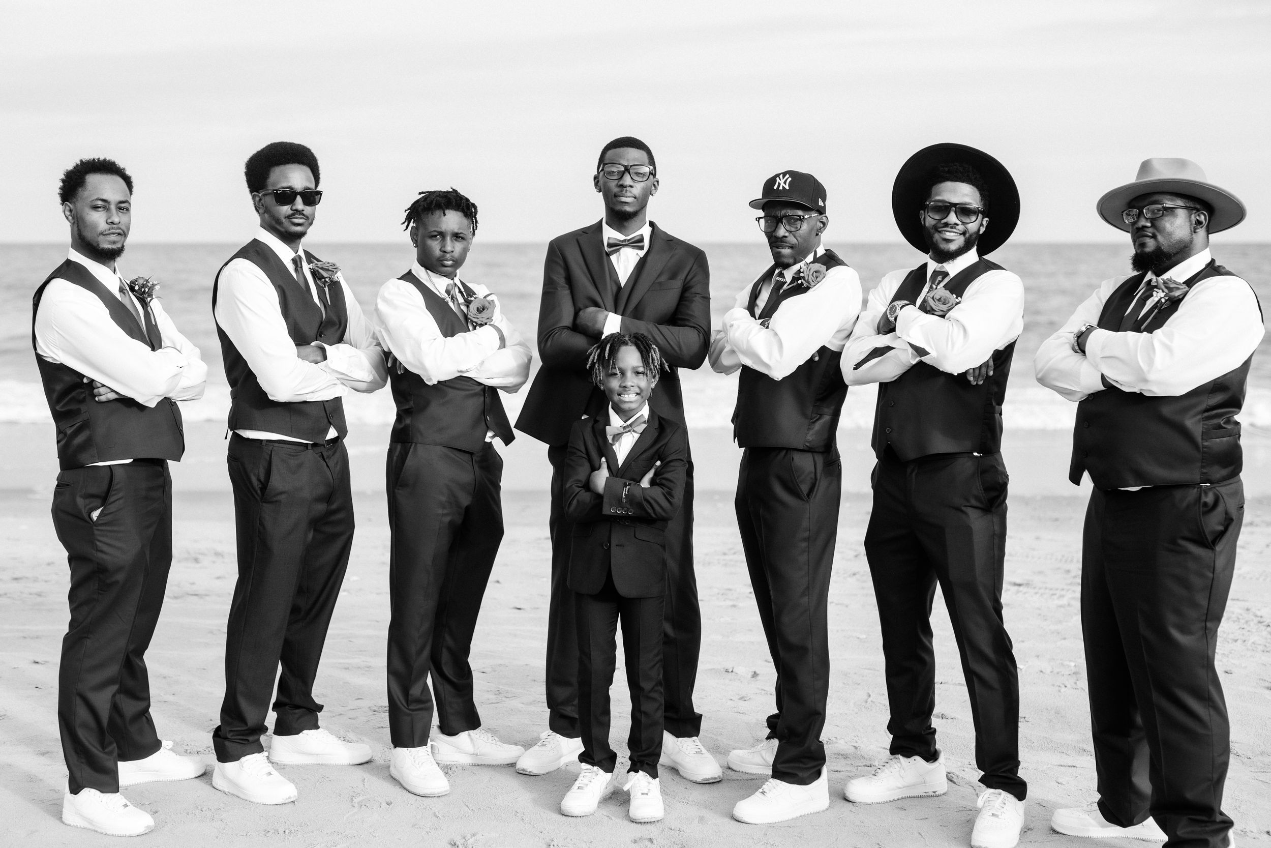 Black and white photo, Groom and his groomsmen on the beach posing cool for his wedding portrait, Essex-County weddings.