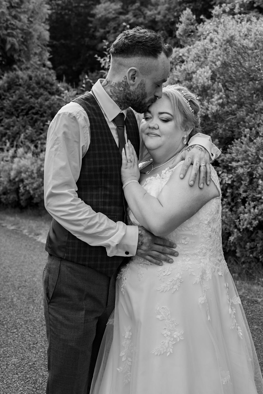 Intimate black and white wedding portraits capturing tender moments between newlyweds.