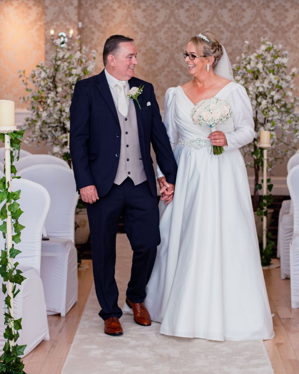 A couple shares an intimate moment during their first dance at a wedding reception.