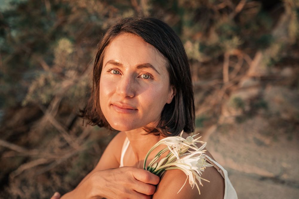 natural cosmetics branding portrait photography sunset Mallorca with flower.