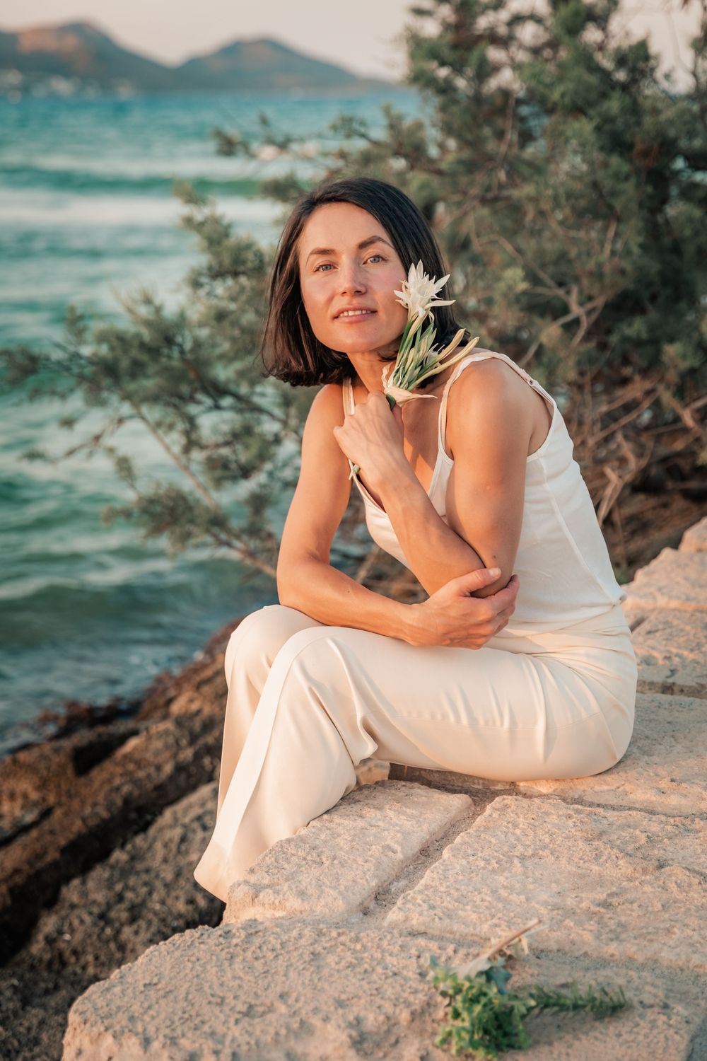 natural cosmetics branding portrait session sunset Mallorca with flower.