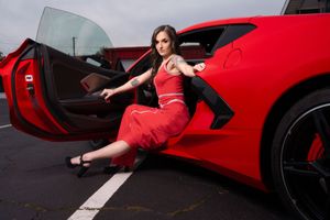 Red Chevrolet Corvette C8 photoshoot featuring model in sleek red dress and reflective surfaces in Charleston, SC.