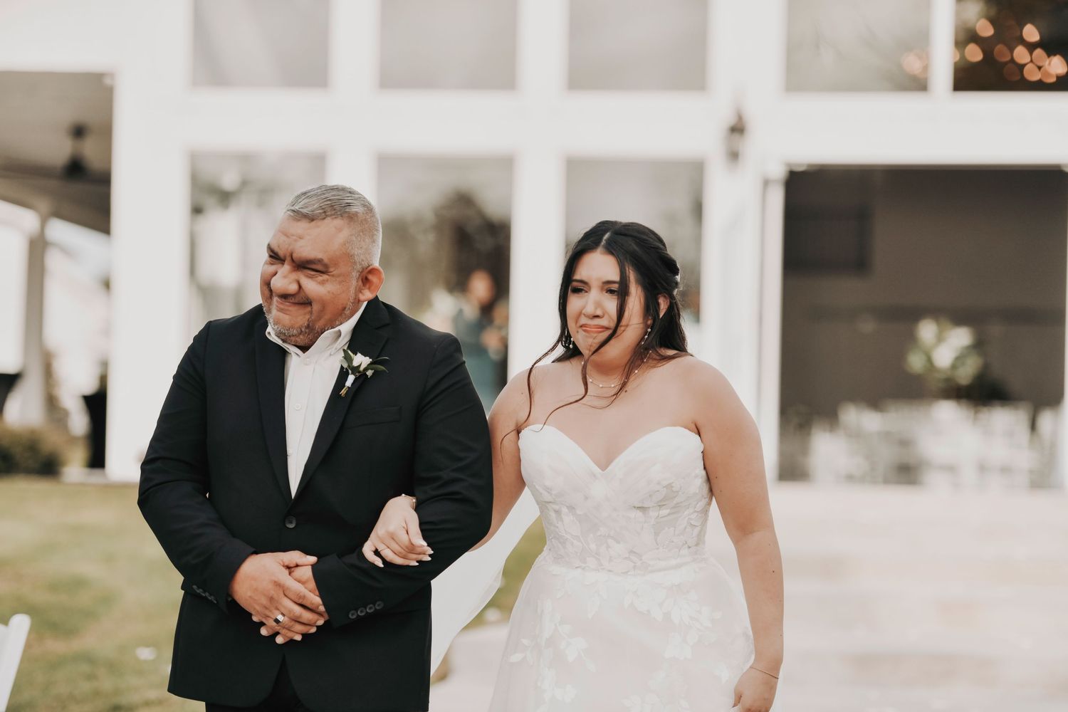 Bride walking down aisle with father during emotional ceremony at Firefly Gardens